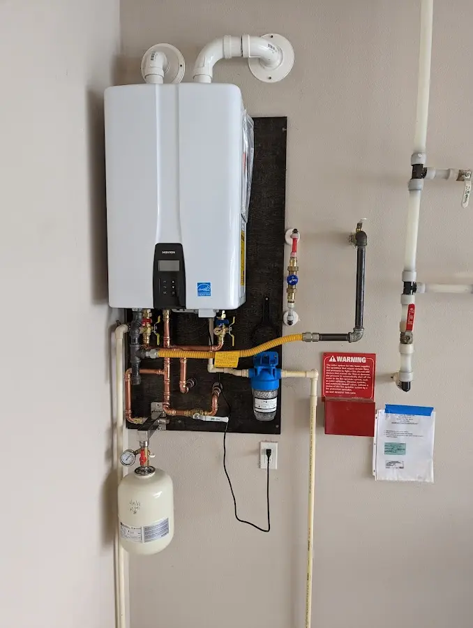 Professional plumber installing copper piping in a East Grand Forks home